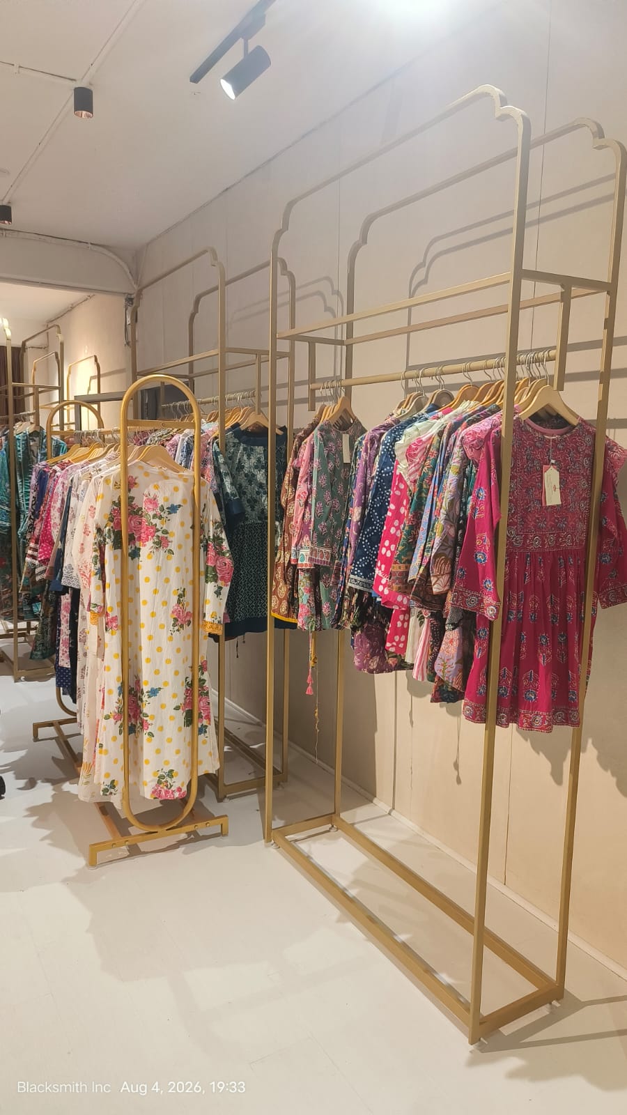 Custom garment display rack manufacturer Jaipur — gold finish boutique installation